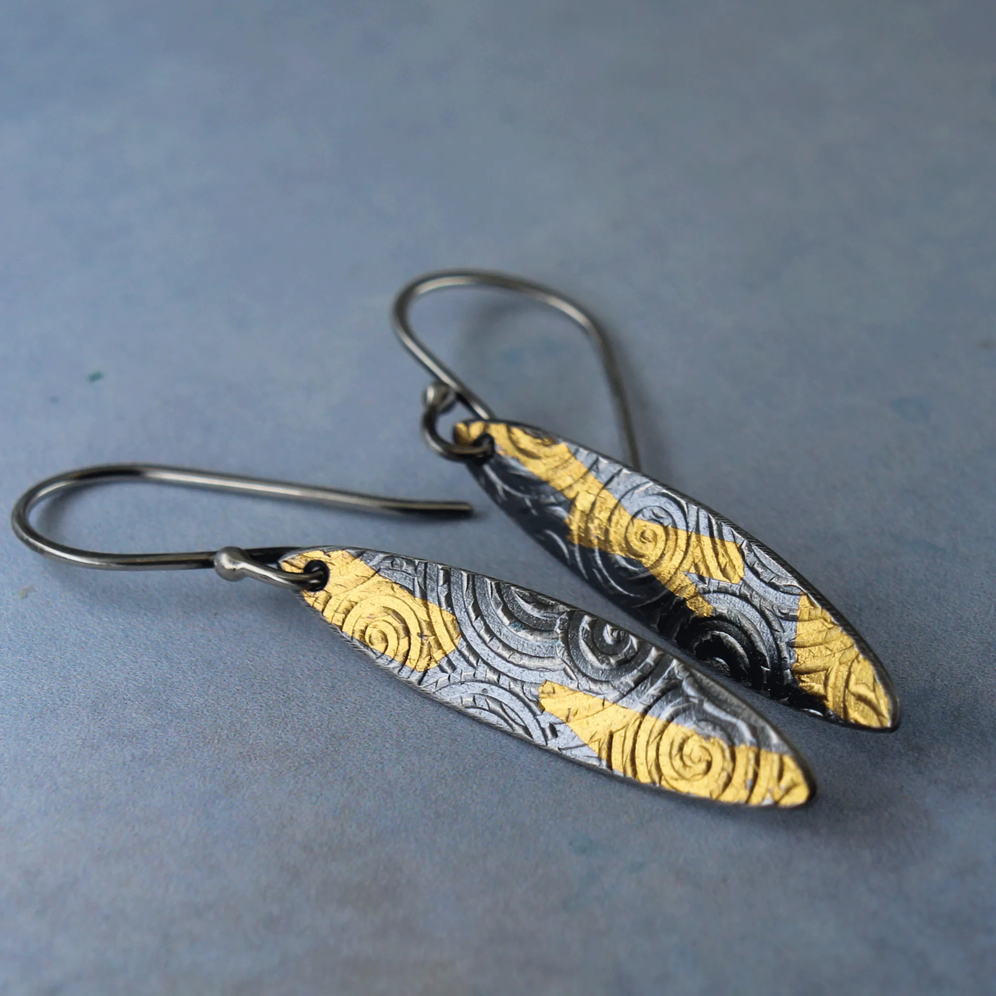 Silver and gold dangle earrings inspired by ancient spirals